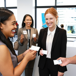 **

A diverse group of people participating in a networking event in New Zealand, with business cards being exchanged and smiles all around. Focus on a modern, bright office space setting.

**